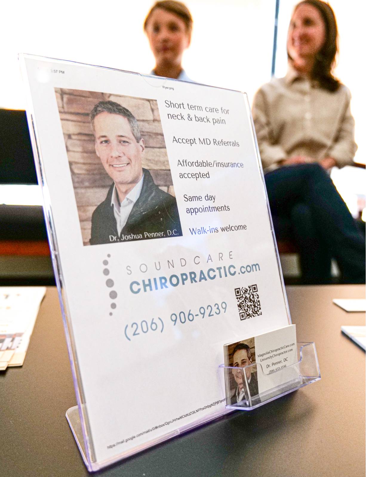 Patient information sign for Sound Care Chiropractic on a desk